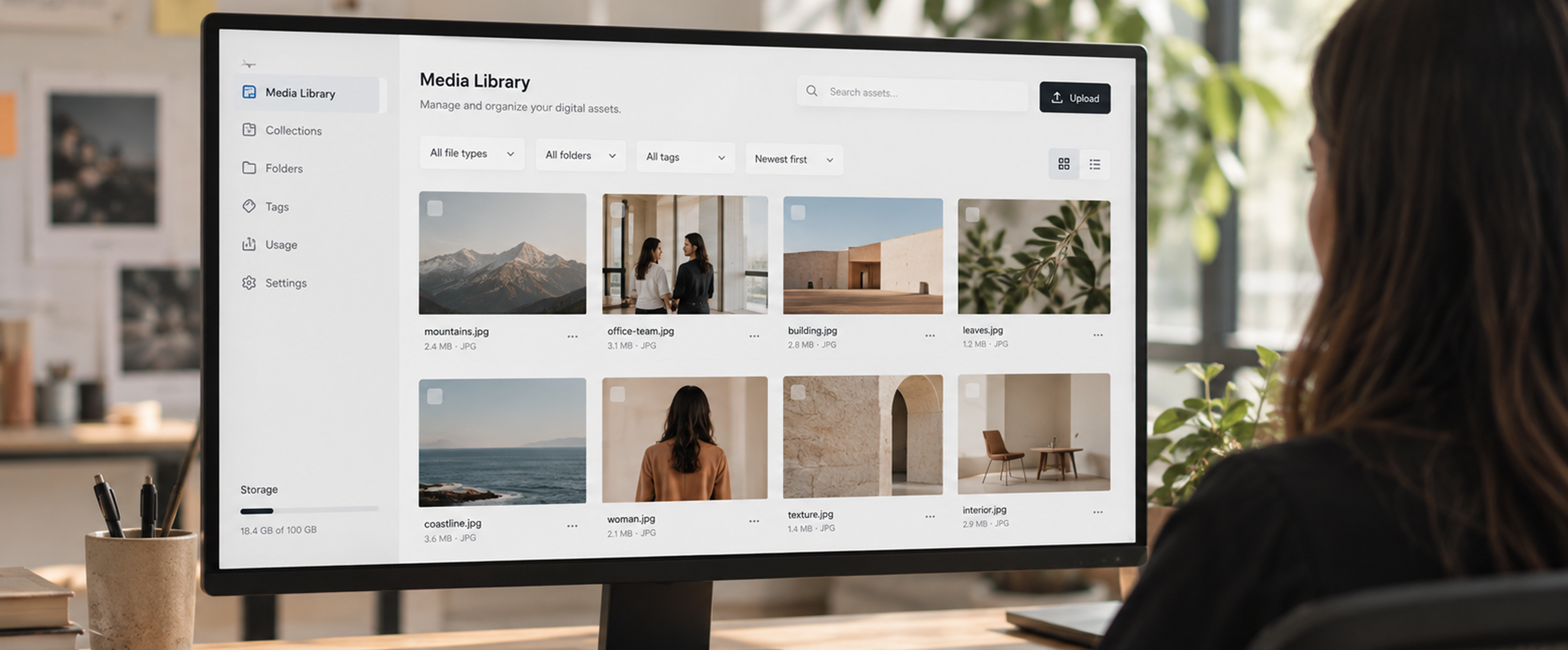 Person viewing a photo gallery website on a desktop monitor.