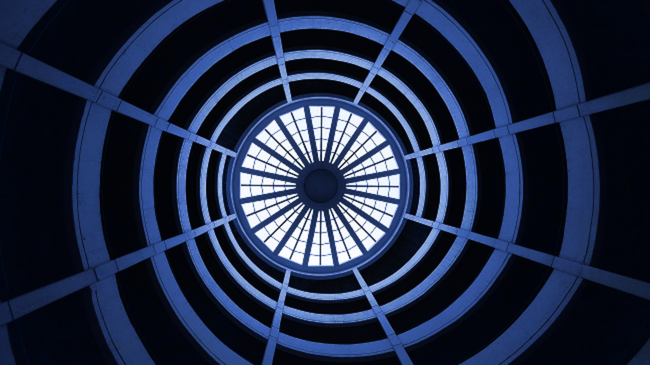 a circular window in a building with a blue sky in the background