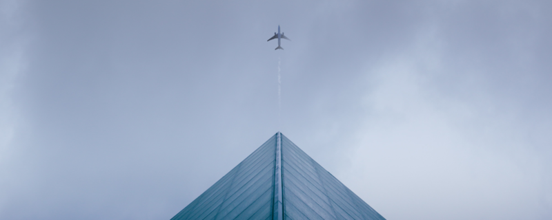 Plane leading a business building