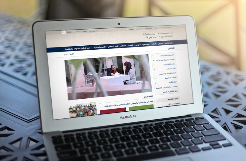 SEO optimized GU-Q Academics Page in Arabic on MacBook Air
