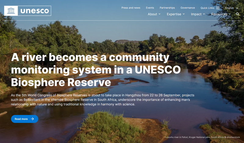UNESCO home page screenshot with a lake and trees 