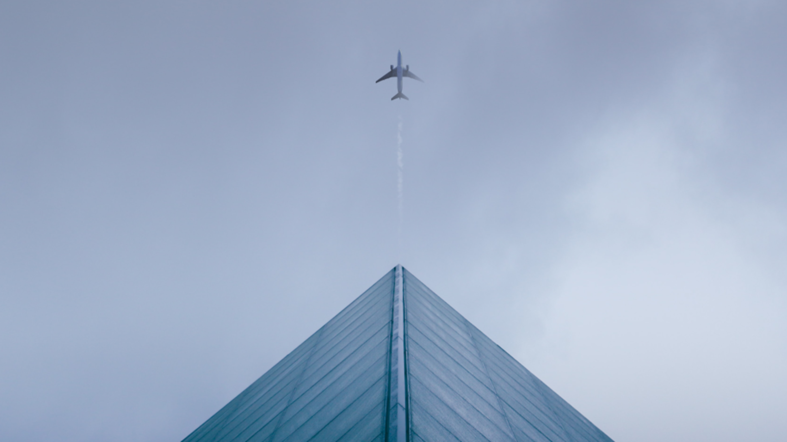 Plane leading a business building